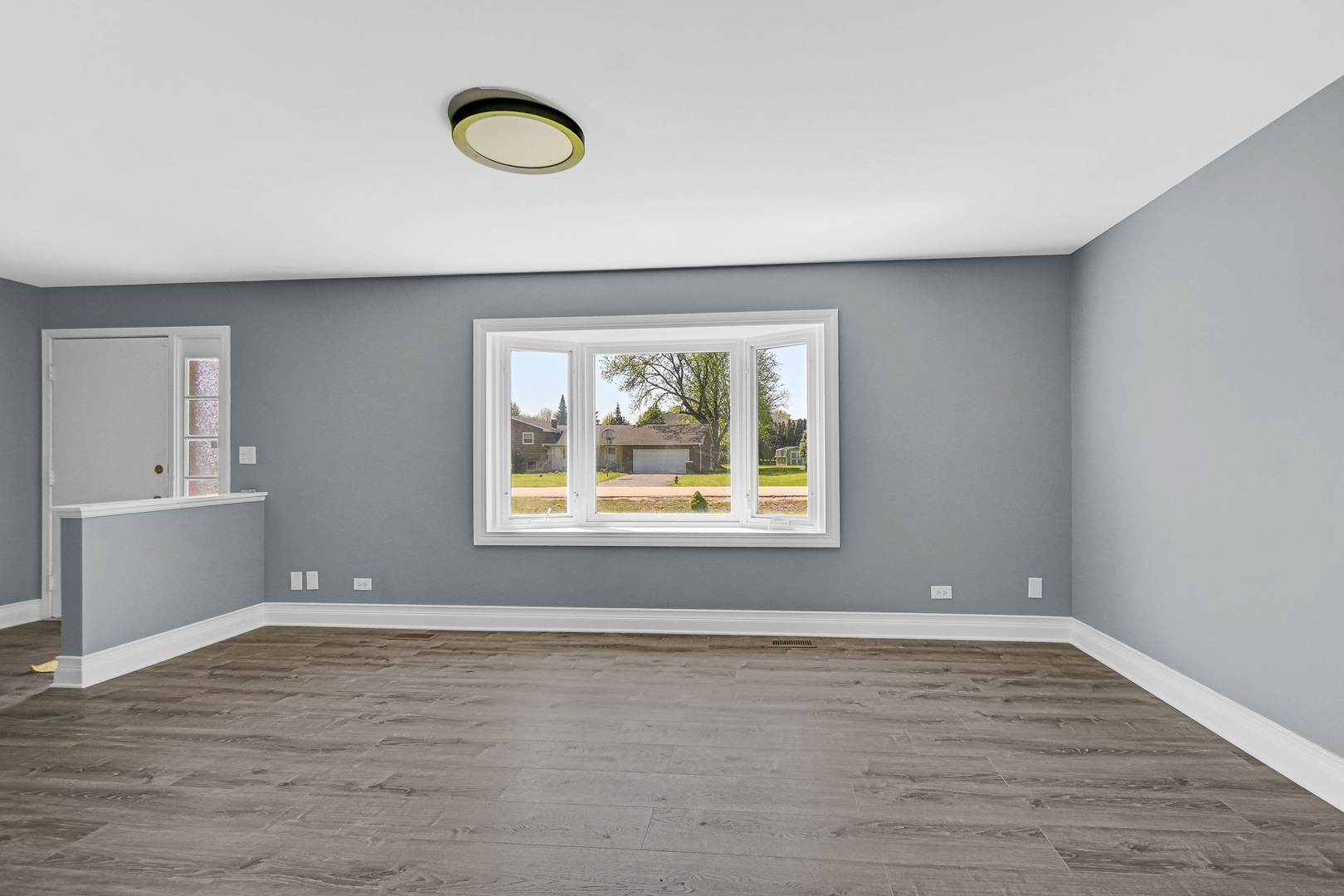 28W502 Leverenz Road Naperville, IL 60564 - Photo 20 of 30 a view of an empty room with wooden floor and a window