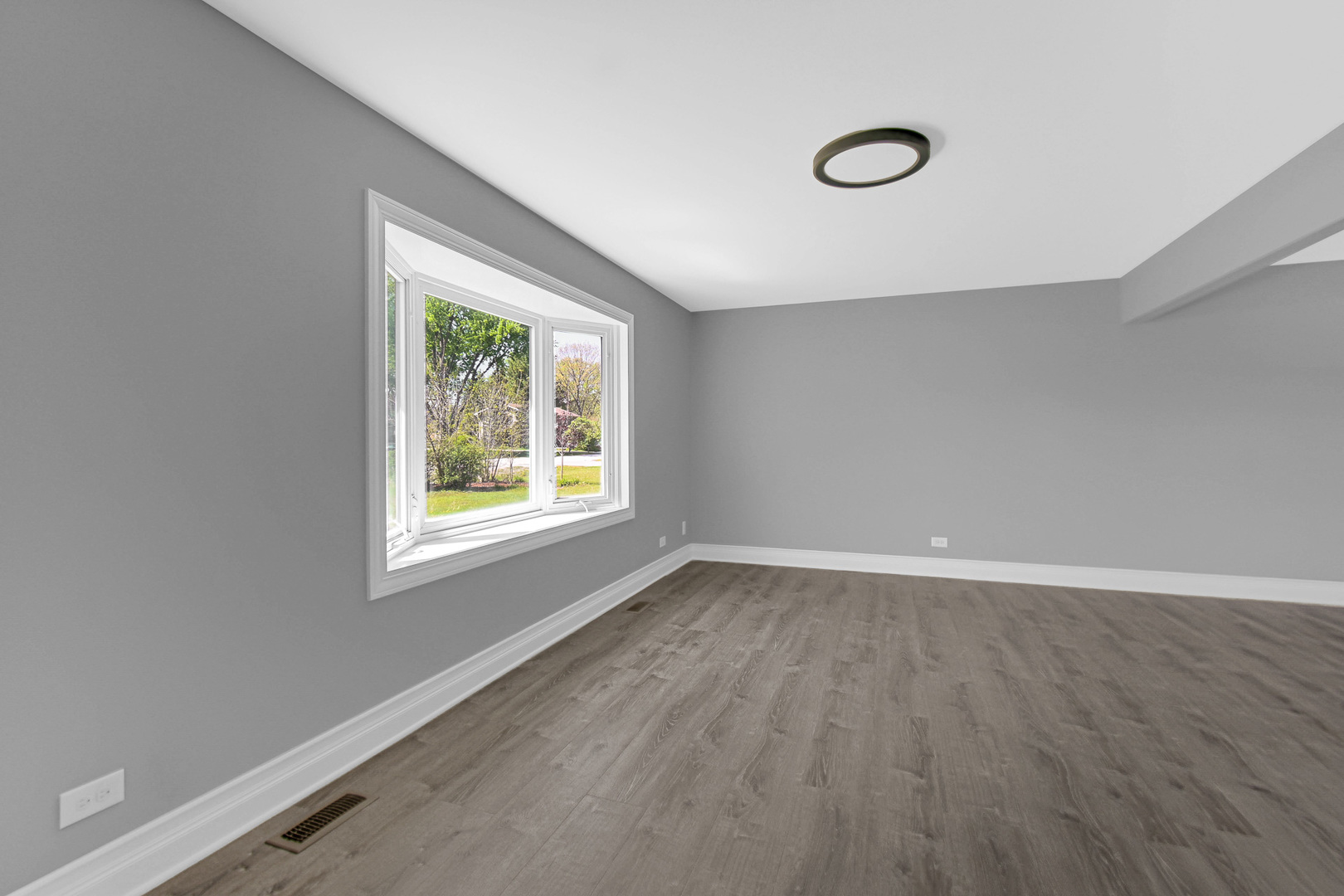 28W502 Leverenz Road Naperville, IL 60564 - Photo 5 of 30 an empty room with wooden floor and windows