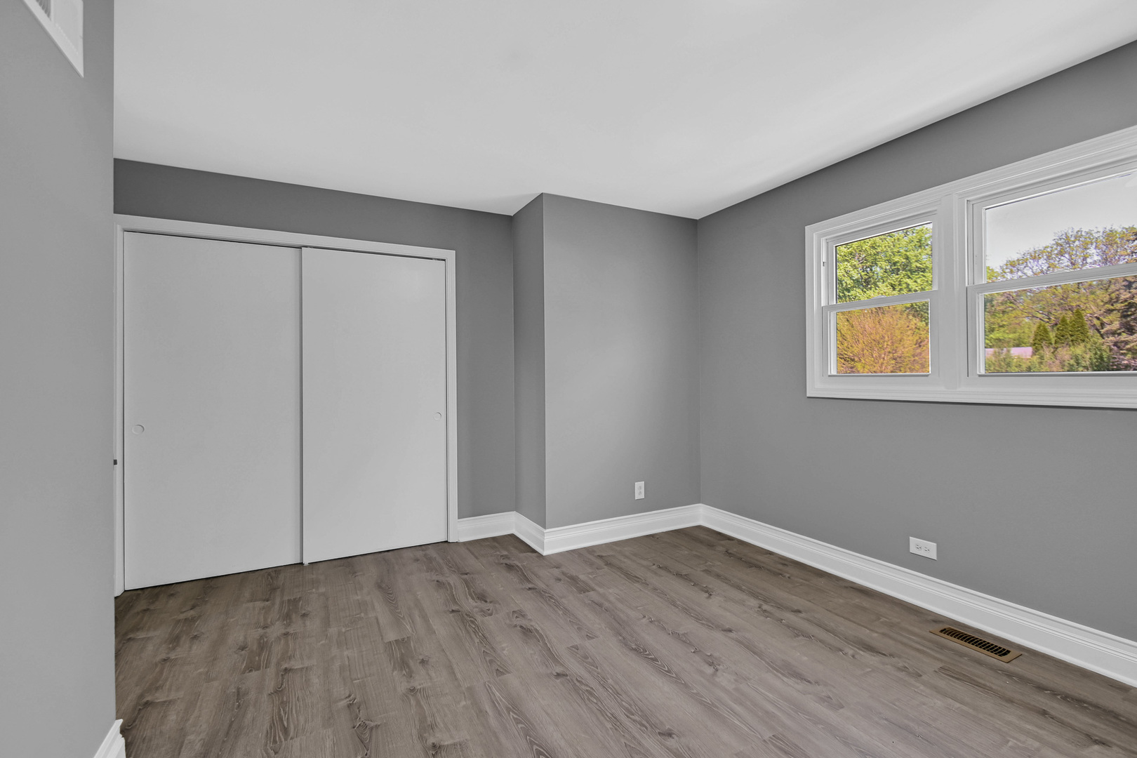 28W502 Leverenz Road Naperville, IL 60564 - Photo 6 of 30 a view of an empty room with wooden floor and a window
