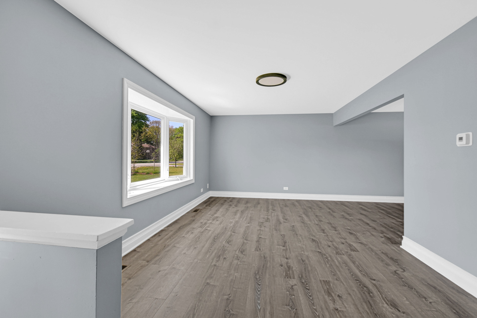 28W502 Leverenz Road Naperville, IL 60564 - Photo 8 of 30 a view of an empty room with wooden floor and a window