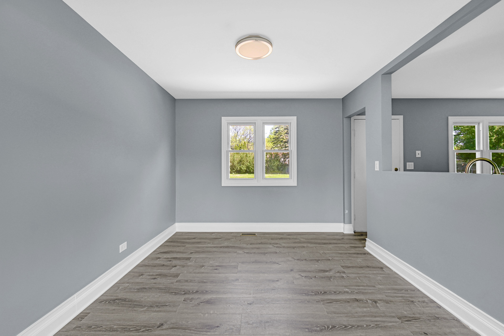28W502 Leverenz Road Naperville, IL 60564 - Photo 9 of 30 an empty room with wooden floor and windows