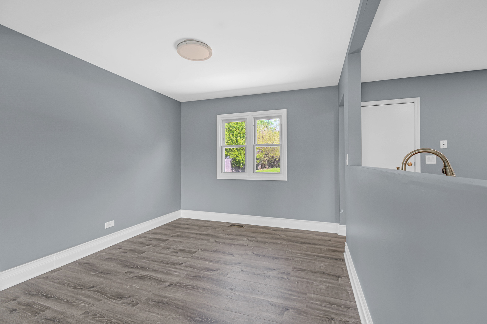 28W502 Leverenz Road Naperville, IL 60564 - Photo 10 of 30 a view of an empty room with window and wooden floor