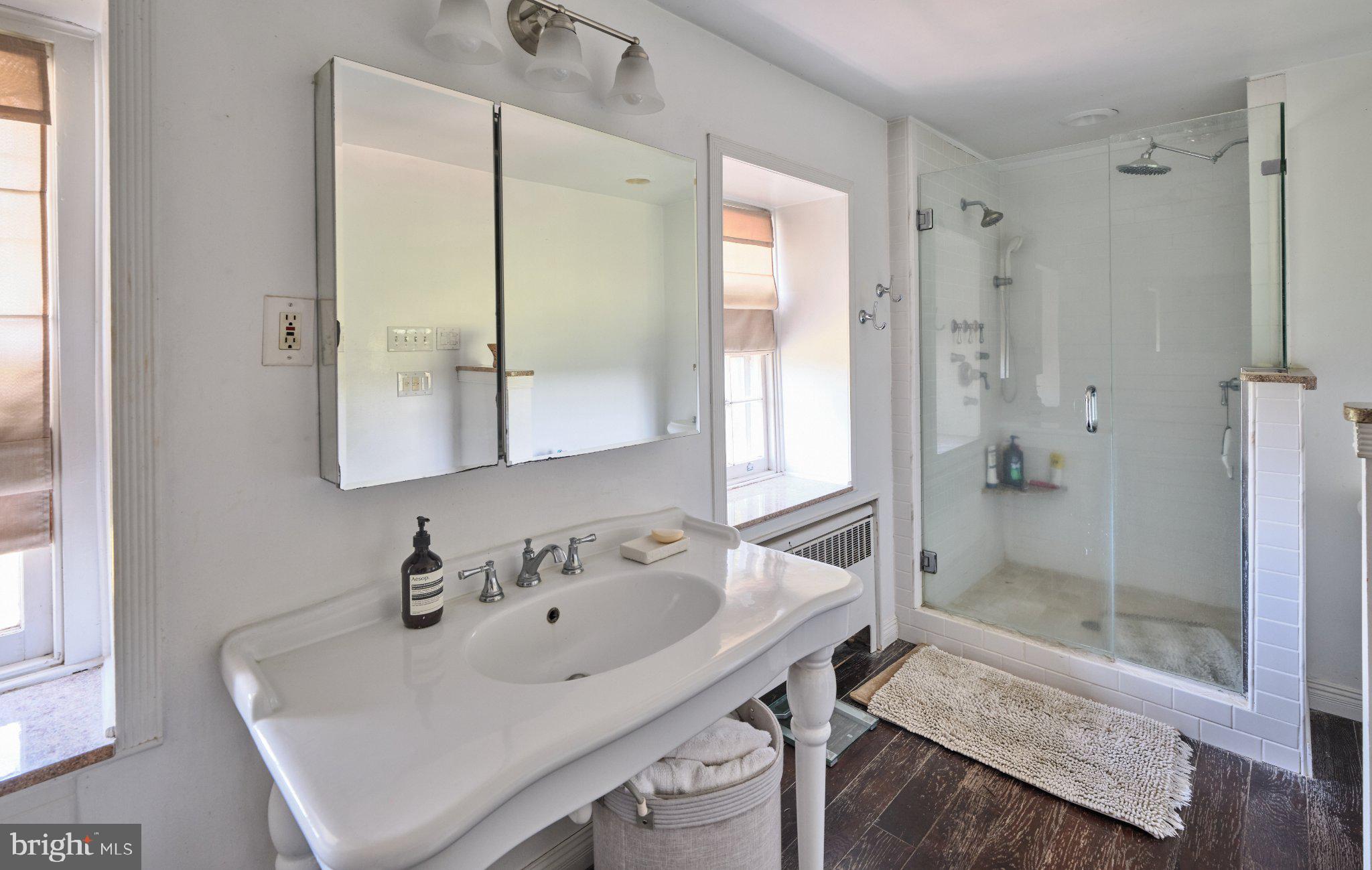 765 Swamp Road Newtown, PA 18940 - Photo 18 of 37 a bathroom with a sink and a mirror