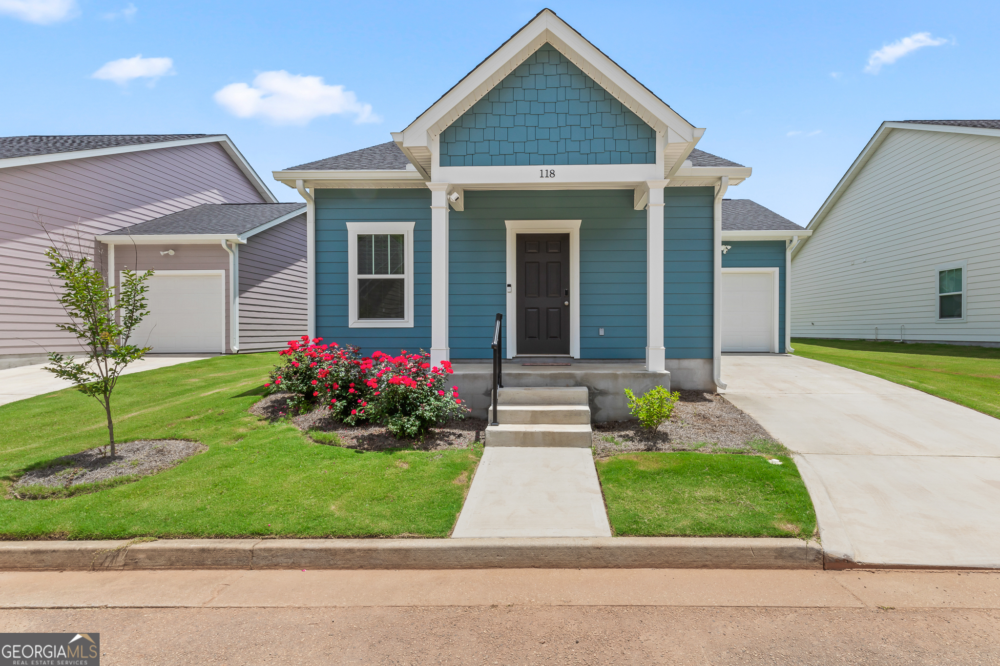 a front view of a house with a yard and porch
