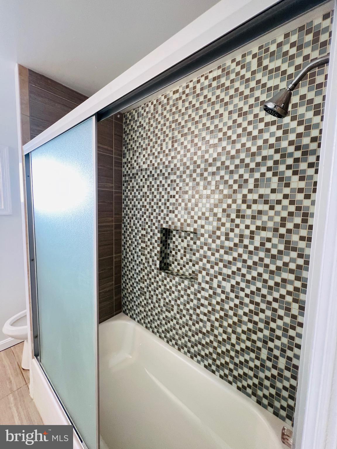 5709 Dade Street Capitol Heights, MD 20743 - Photo 16 of 23 a bathroom with a bathtub and shower