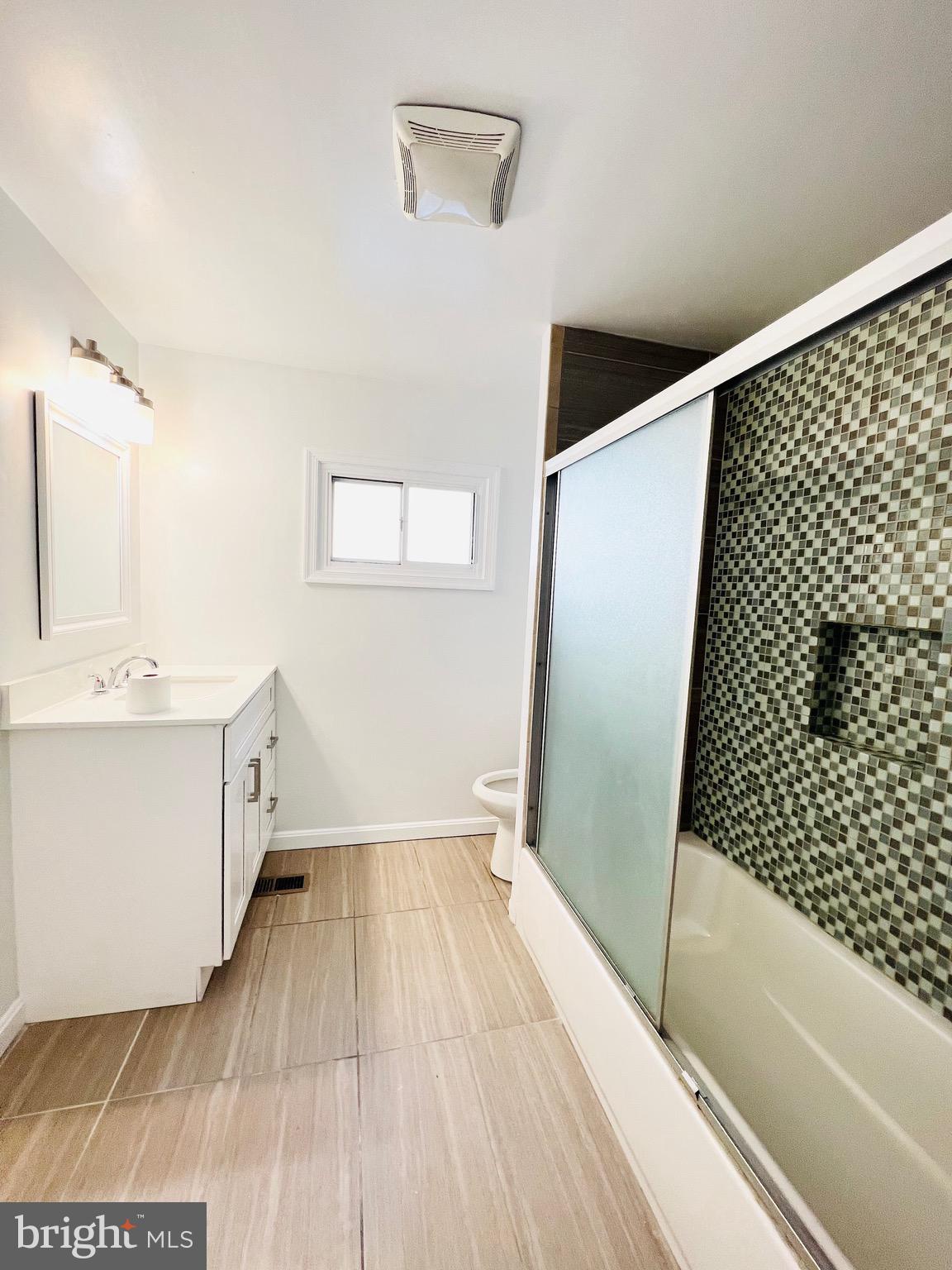 5709 Dade Street Capitol Heights, MD 20743 - Photo 17 of 23 a bathroom with a bathtub and a sink
