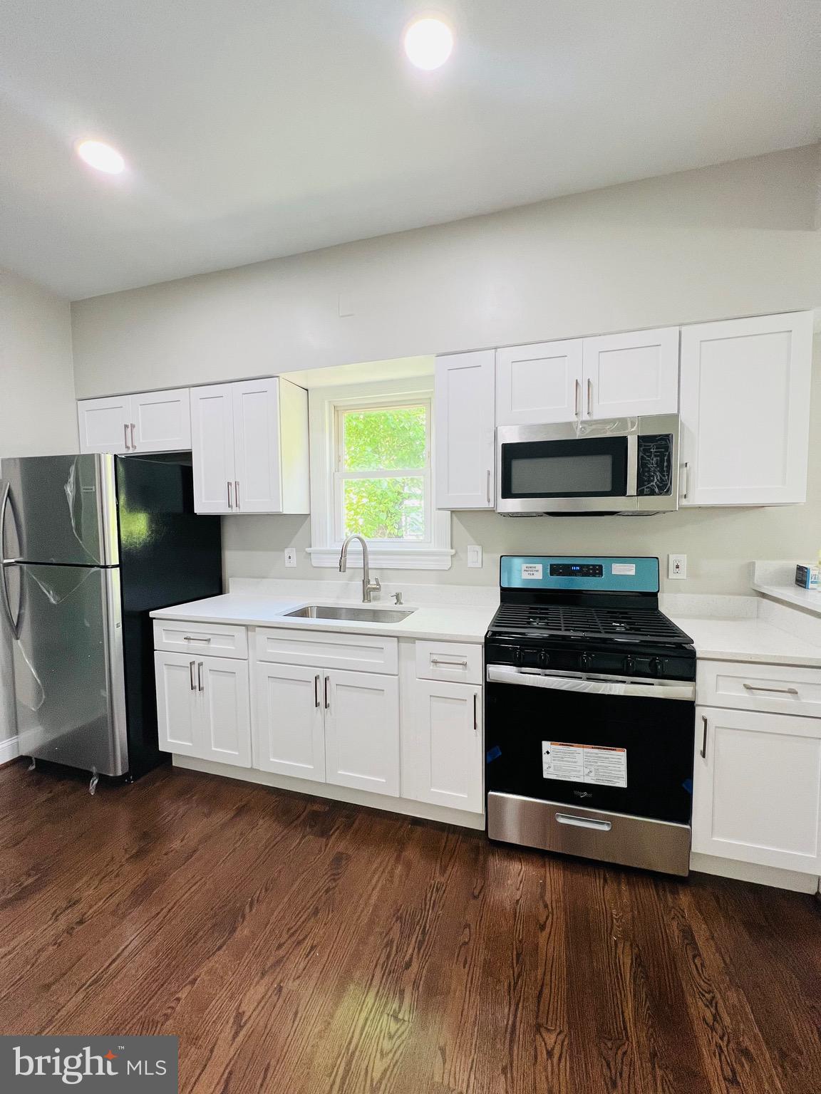 5709 Dade Street Capitol Heights, MD 20743 - Photo 18 of 23 a kitchen with a refrigerator stove and wooden cabinets
