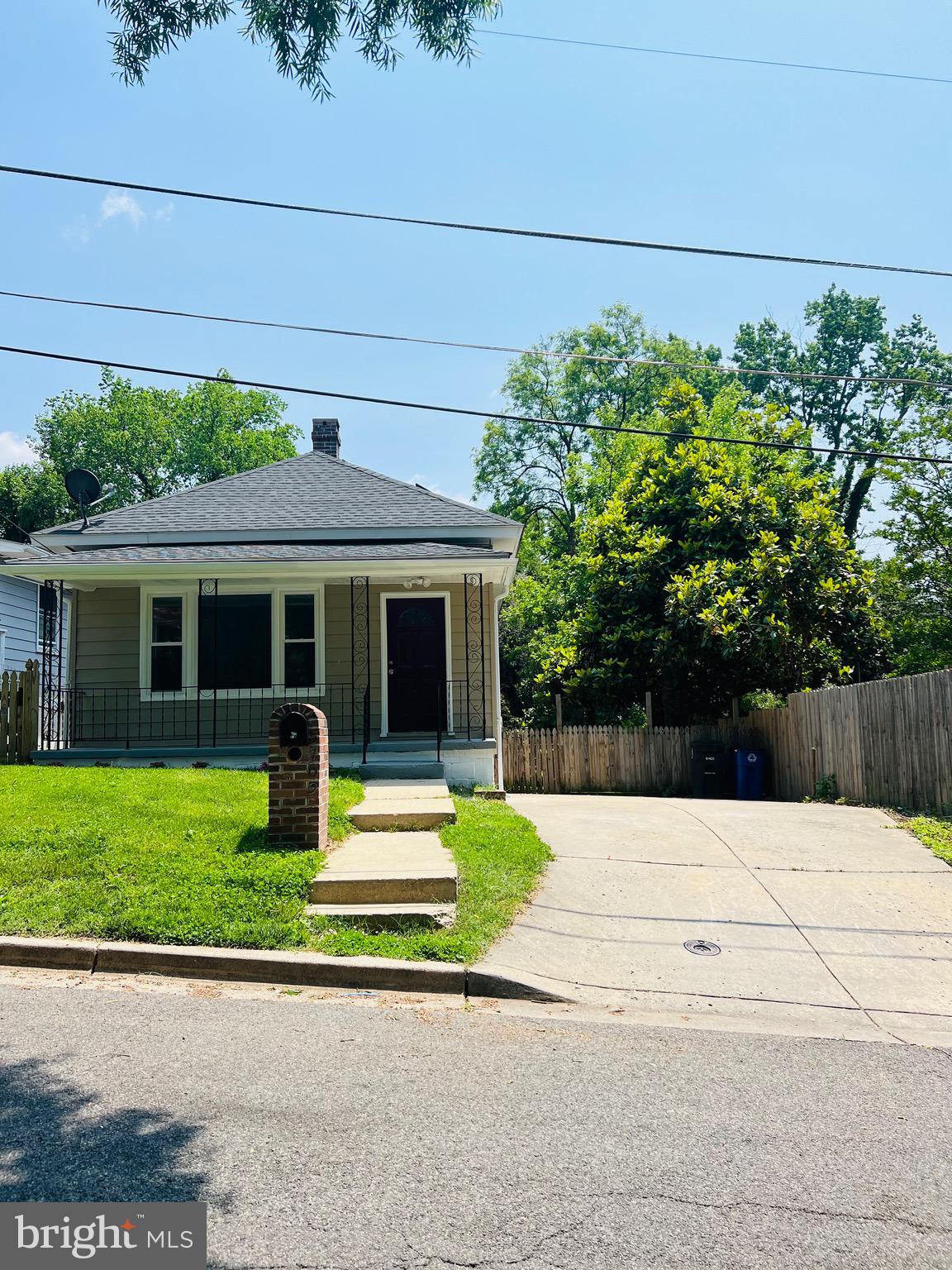 5709 Dade Street Capitol Heights, MD 20743 - Photo 2 of 23 a house with a garden and pathway