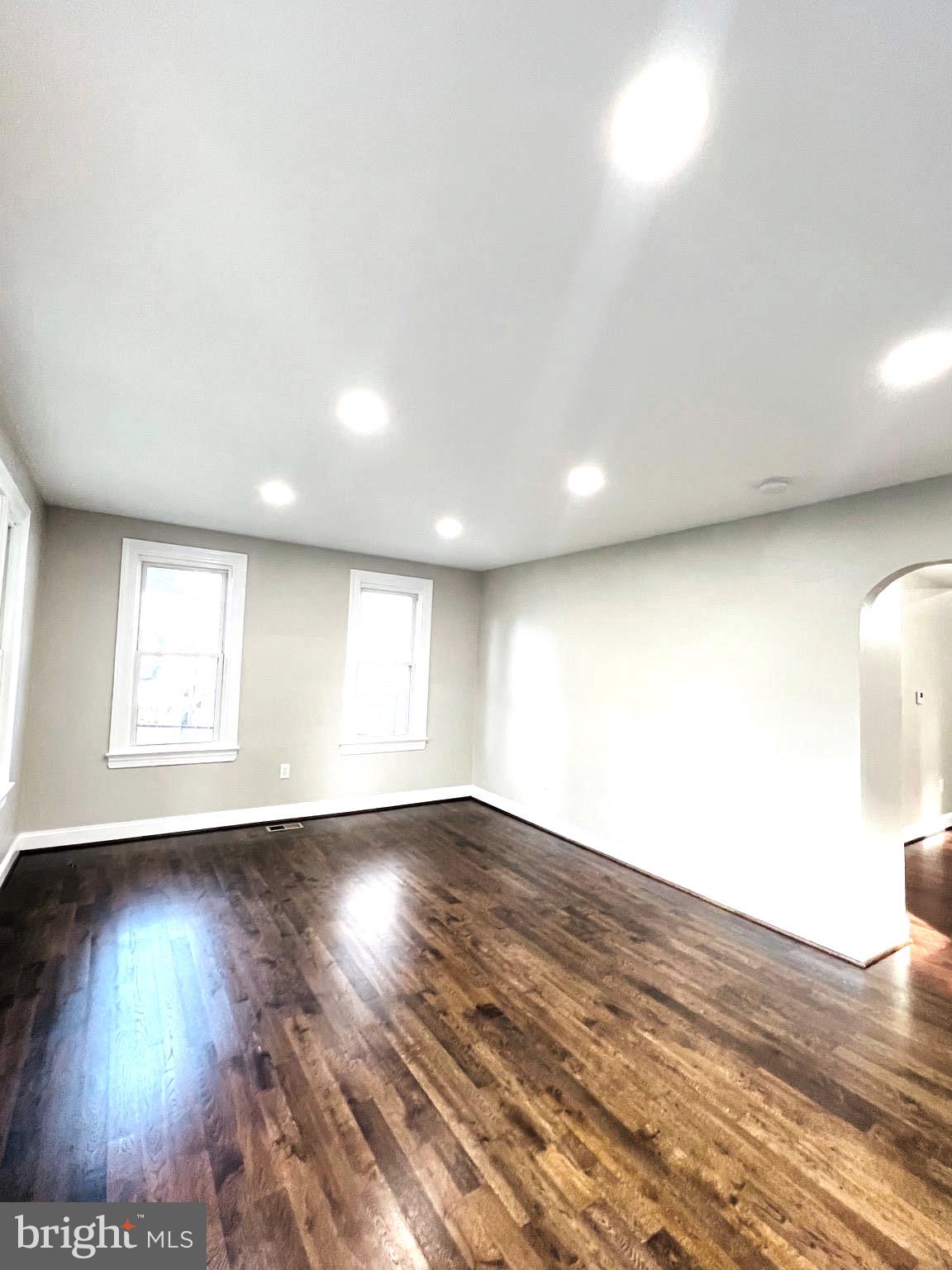5709 Dade Street Capitol Heights, MD 20743 - Photo 3 of 23 an empty room with wooden floor and windows
