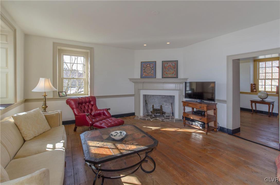 50 Durham Road Easton, PA 18042 - Photo 3 of 31 a living room with furniture a fireplace a flat screen tv and a large window
