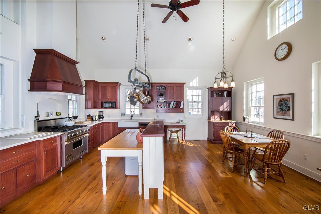 50 Durham Road Easton, PA 18042 - Photo 6 of 31 a kitchen with stainless steel appliances granite countertop a stove top oven a dining table and chairs with wooden floor