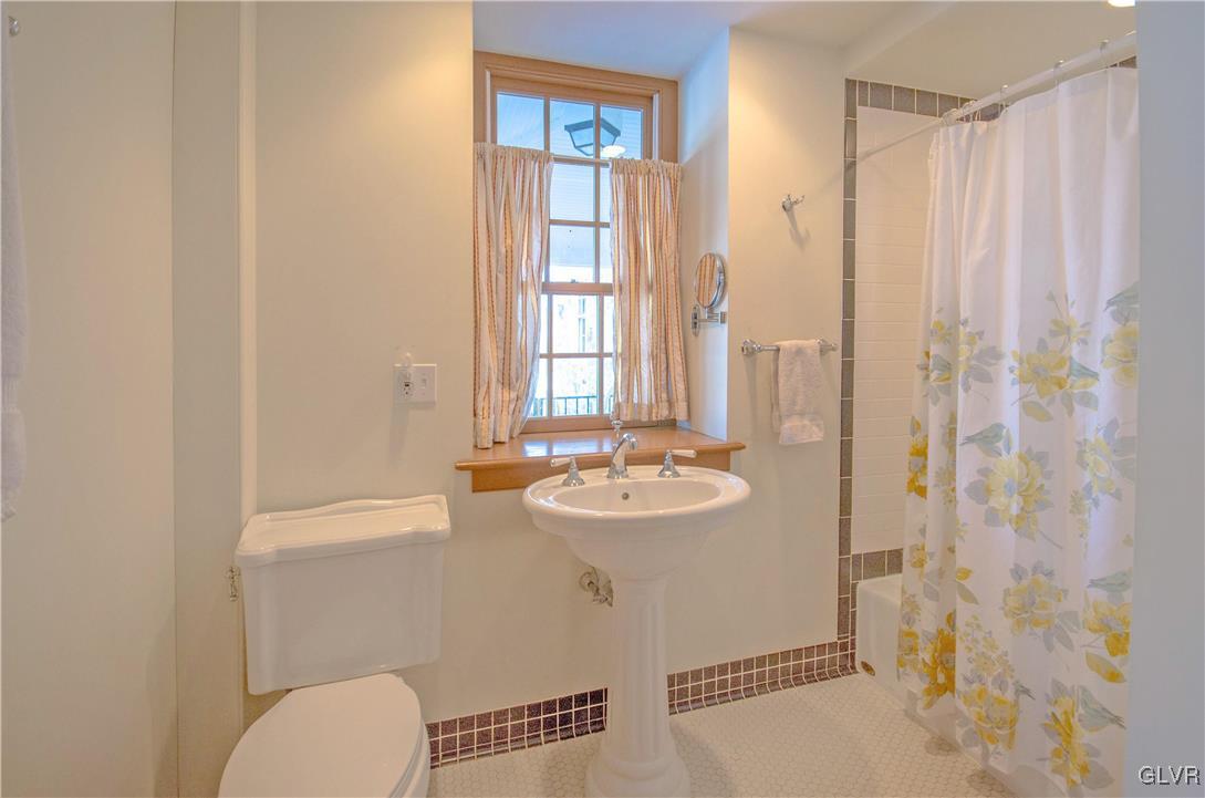 50 Durham Road Easton, PA 18042 - Photo 10 of 31 a bathroom with a sink a toilet and shower curtain