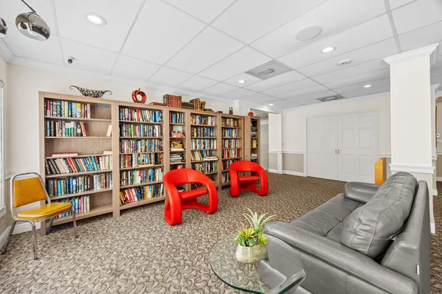 a living room with furniture and book shelf