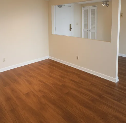 an empty room with wooden floor