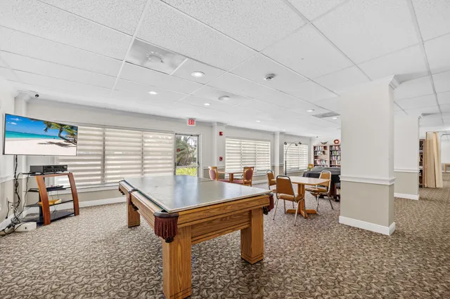 a room with furniture pool table and windows