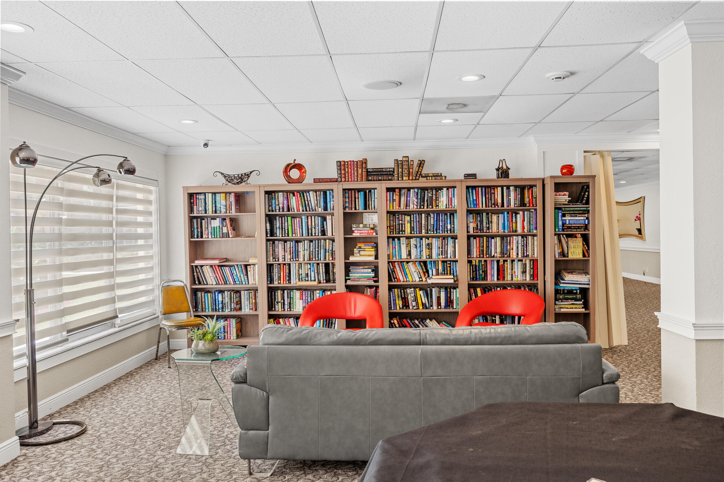 10777 West Sample Road, Unit 508 Coral Springs, FL 33065 - Photo 10 of 25 a living room with lots of furniture and white walls