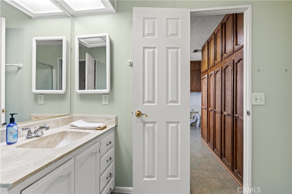 5200 Irvine Boulevard Irvine, CA 92620 - Photo 25 of 52 a bathroom with a sink and a mirror