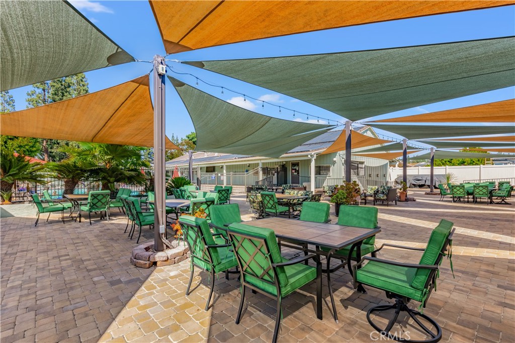 5200 Irvine Boulevard Irvine, CA 92620 - Photo 36 of 52 a view of a patio with a table and chairs under an umbrella
