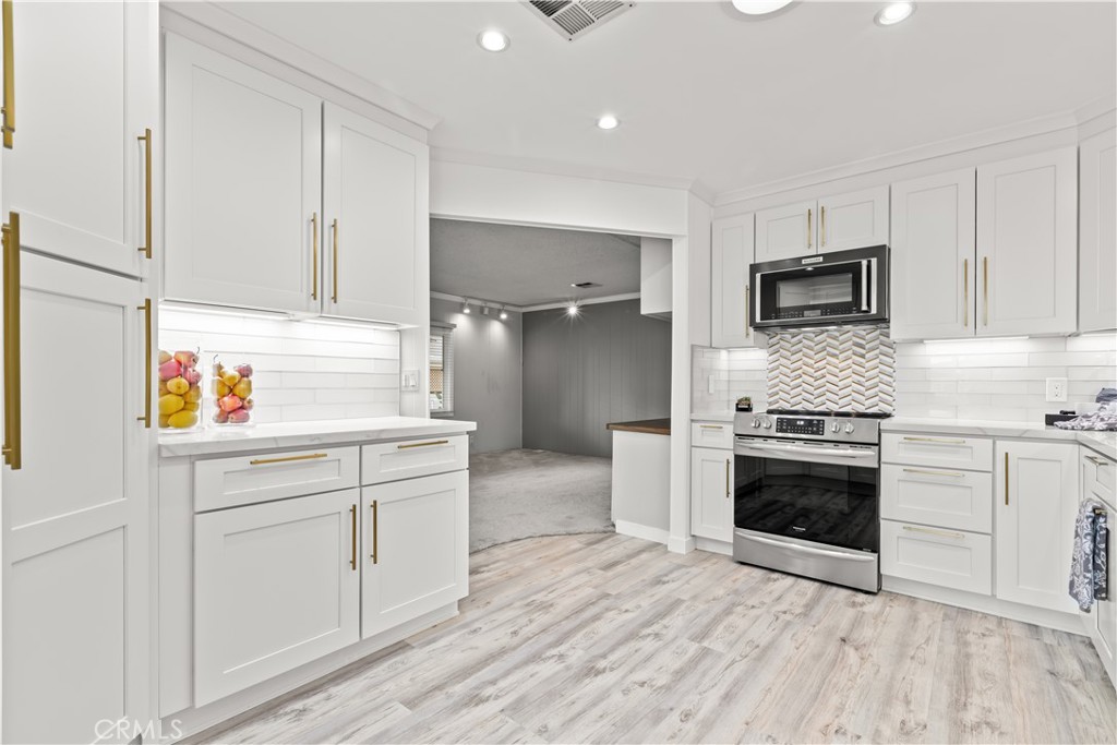 5200 Irvine Boulevard Irvine, CA 92620 - Photo 7 of 52 a kitchen with stainless steel appliances granite countertop a stove a sink and a refrigerator