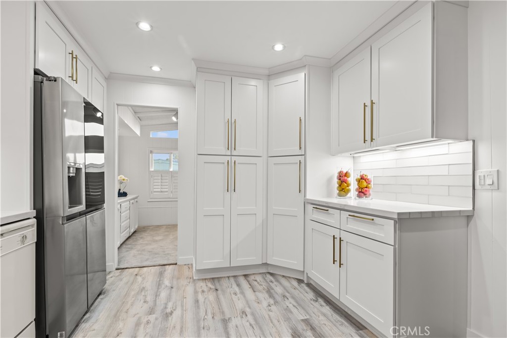 5200 Irvine Boulevard Irvine, CA 92620 - Photo 9 of 52 a kitchen with white cabinets and refrigerator