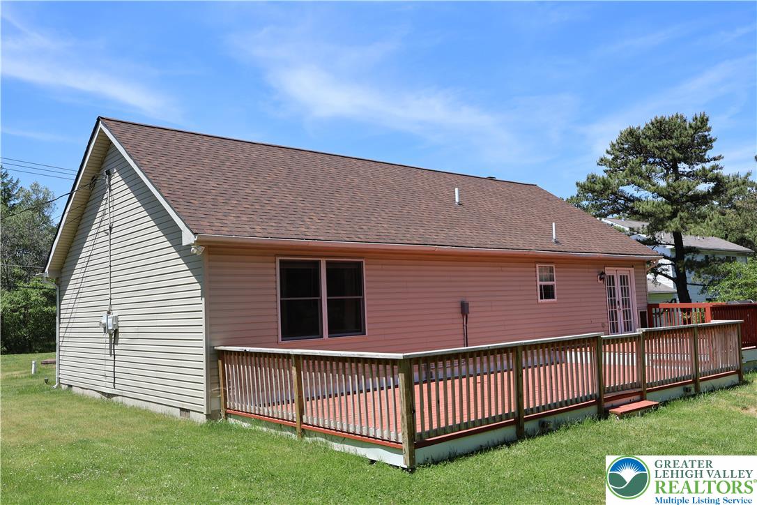 1646 Clover Road Long Pond, PA 18334 - Photo 15 of 20 a backyard of a house with a garden and deck
