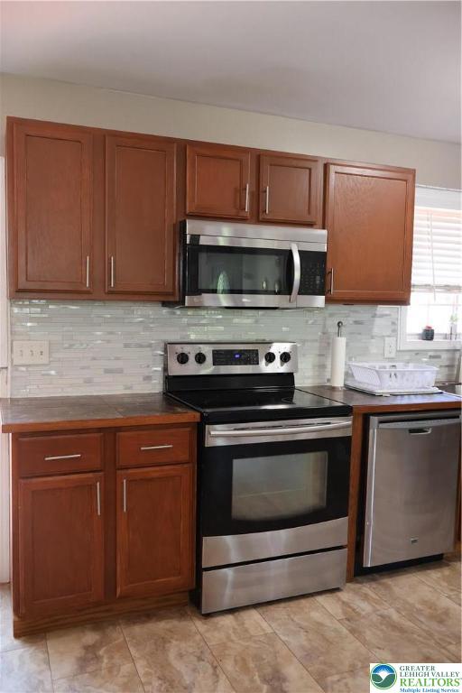 1646 Clover Road Long Pond, PA 18334 - Photo 4 of 20 a kitchen with granite countertop a stove microwave and sink