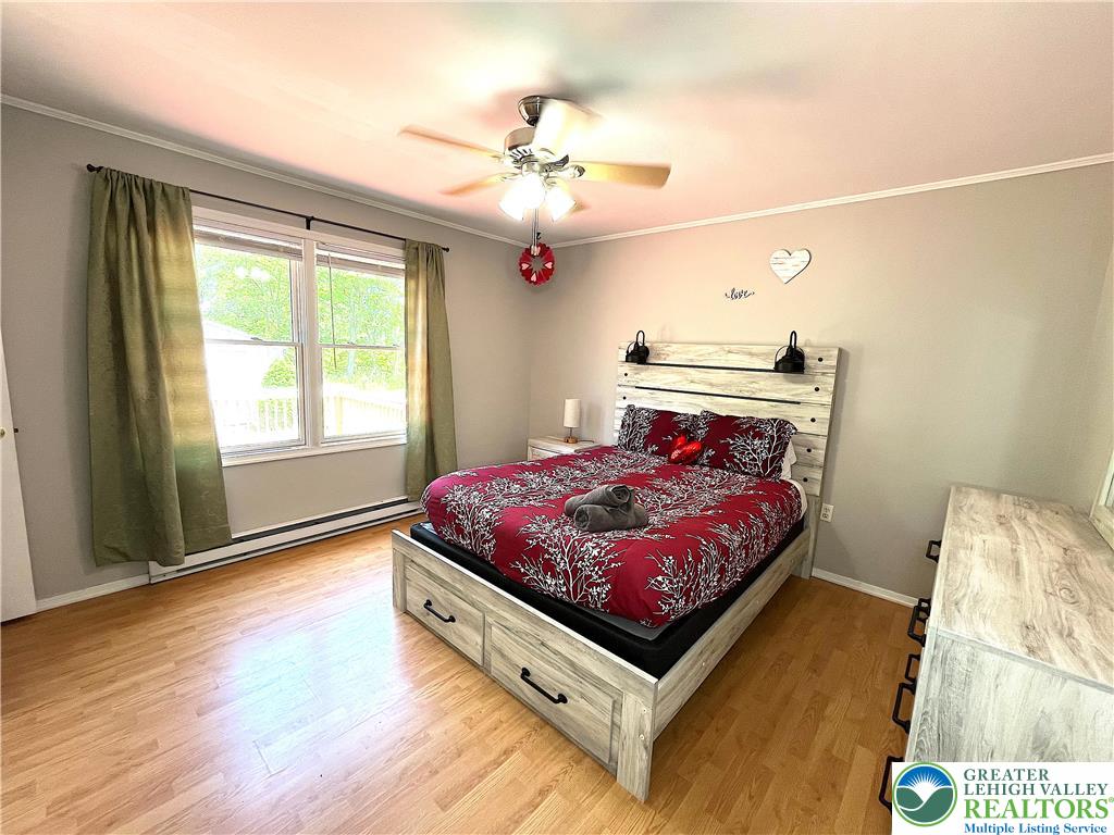 1646 Clover Road Long Pond, PA 18334 - Photo 8 of 20 a bedroom with a bed and a chandelier