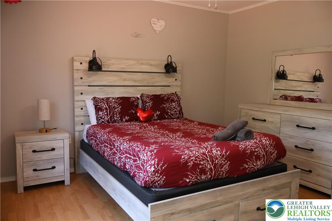 1646 Clover Road Long Pond, PA 18334 - Photo 9 of 20 a bedroom with a bed and a night stand