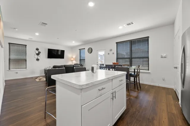 a kitchen with a sink cabinets and wooden floor