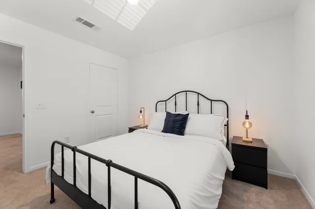 a bedroom with a bed and a window