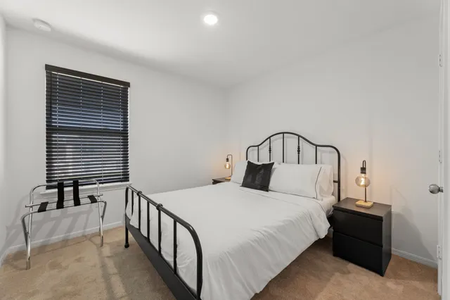 a bedroom with a bed and a night stand