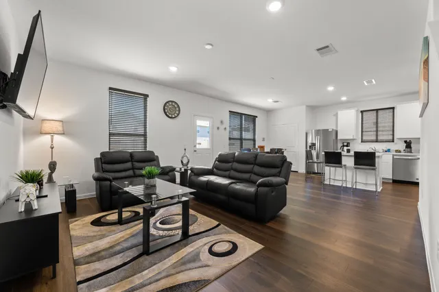 a living room with furniture and wooden floor
