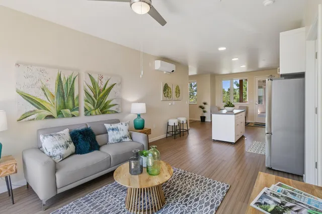 a living room with furniture wooden floor and a table