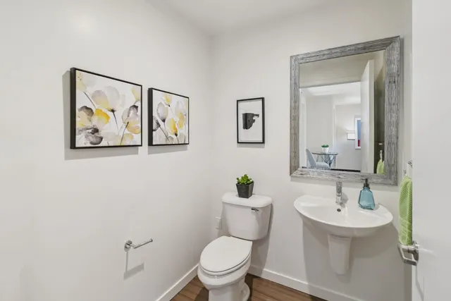 a bathroom with a toilet sink and mirror