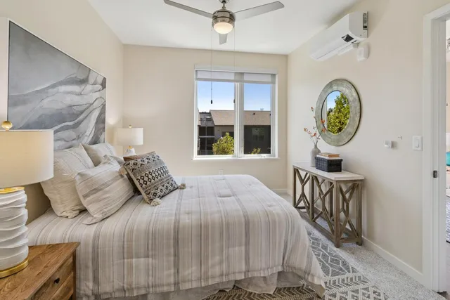 a bedroom with a bed and a window