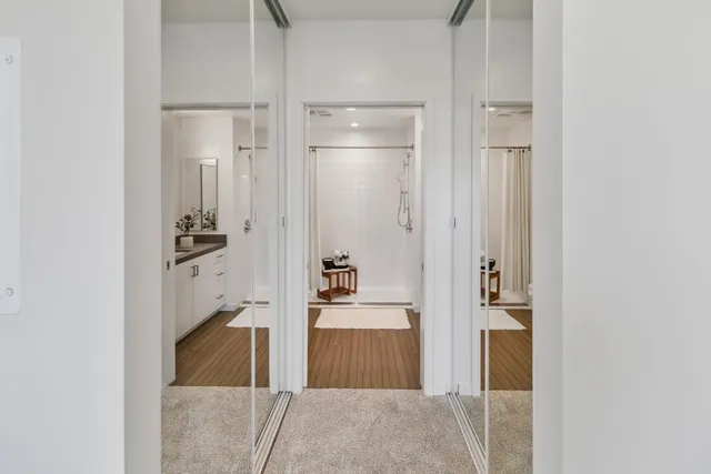 a room with a walk in closet and a couch