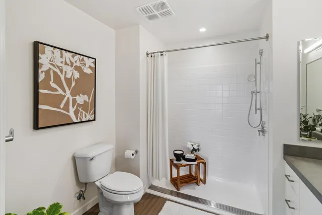 a bathroom with a toilet a sink and shower