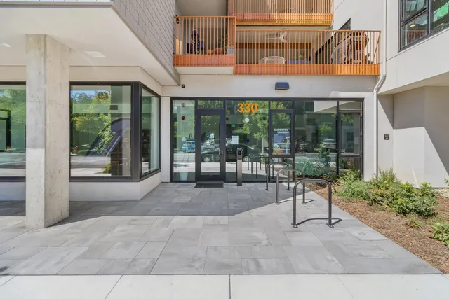 a patio with glass top table and chairs