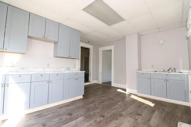 a kitchen with granite countertop white cabinets and white appliances