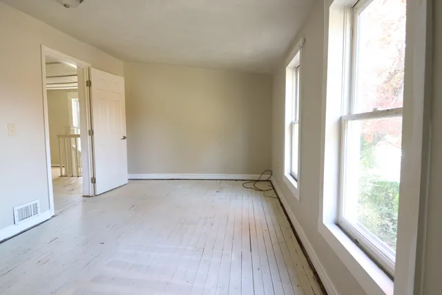 a view of an empty room and glass door