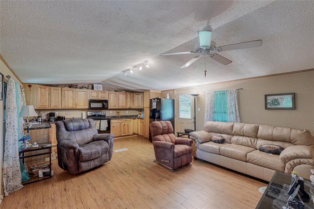1501 Joyce Road Kaufman, TX 75142 - Photo 16 of 37 a living room with furniture and a wooden floor