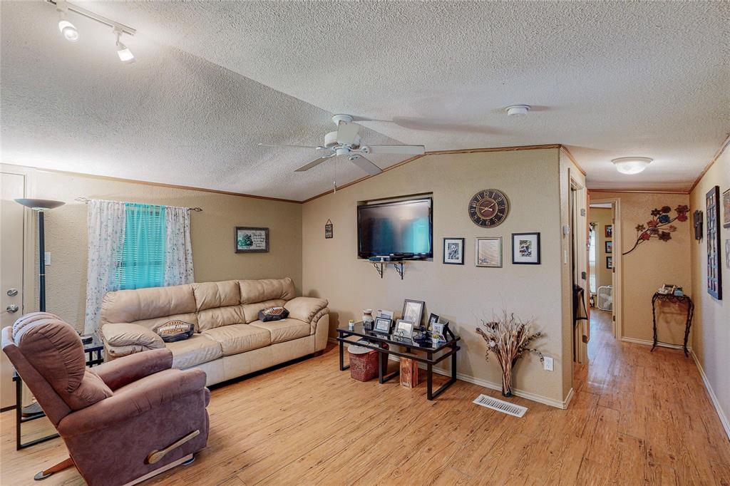 1501 Joyce Road Kaufman, TX 75142 - Photo 17 of 37 a living room with furniture and a flat screen tv