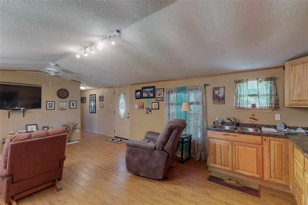1501 Joyce Road Kaufman, TX 75142 - Photo 18 of 37 a living room with furniture and flat screen tv