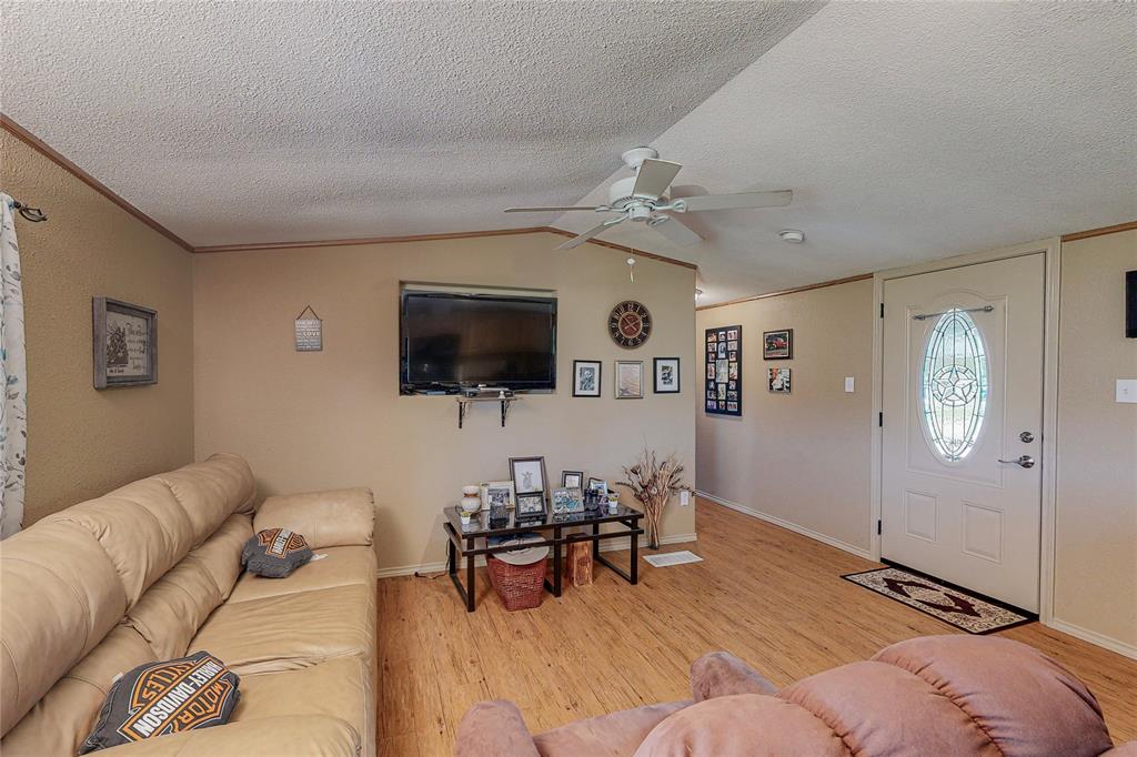 1501 Joyce Road Kaufman, TX 75142 - Photo 19 of 37 a living room with furniture and a flat screen tv