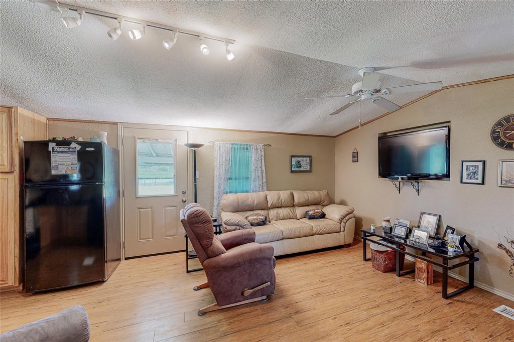 1501 Joyce Road Kaufman, TX 75142 - Photo 20 of 37 a living room with furniture and a flat screen tv