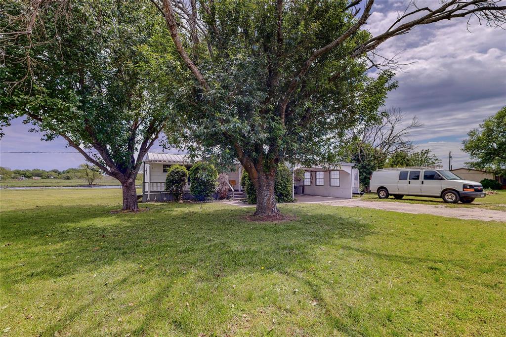 1501 Joyce Road Kaufman, TX 75142 - Photo 2 of 37 a front view of a house with a garden and trees