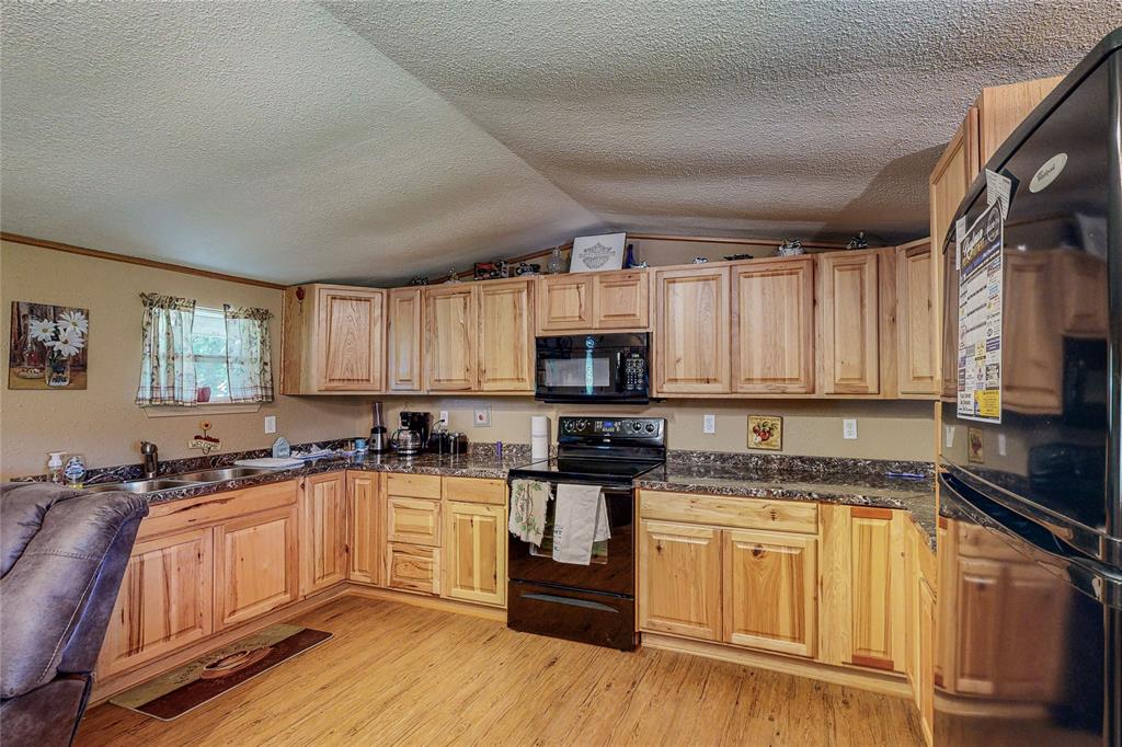 1501 Joyce Road Kaufman, TX 75142 - Photo 22 of 37 a kitchen with a sink stove top oven and refrigerator
