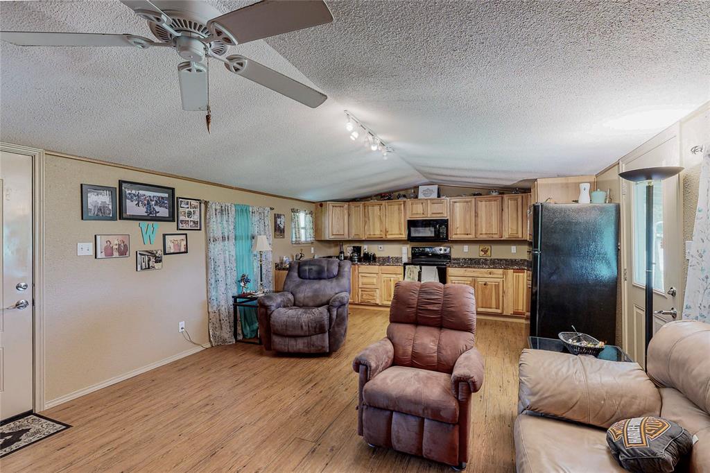1501 Joyce Road Kaufman, TX 75142 - Photo 24 of 37 a living room with furniture and a wooden floor