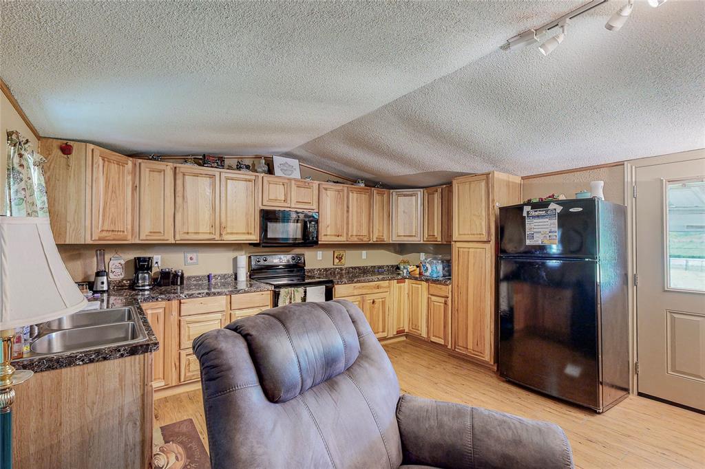 1501 Joyce Road Kaufman, TX 75142 - Photo 25 of 37 a kitchen with stainless steel appliances granite countertop a refrigerator stove top oven a sink and dishwasher