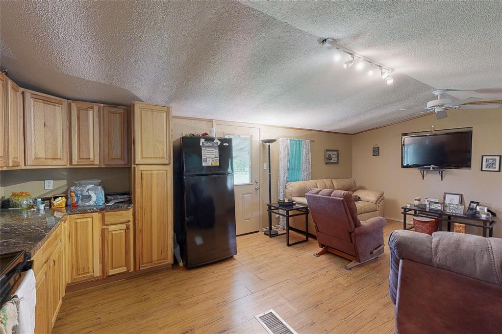 1501 Joyce Road Kaufman, TX 75142 - Photo 26 of 37 a living room with furniture and a flat screen tv